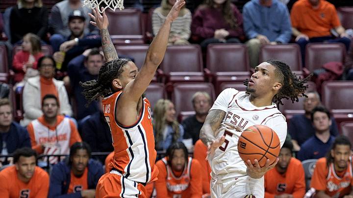 Jan 4, 2025; Tallahassee, Florida, USA; Florida State Seminoles guard DaQuan Davis (5) shoots the ball against Syracuse Orange guard JaQuan Carlos (5) during the first half at Donald L. Tucker Center. Mandatory Credit: Melina Myers-Imagn Images