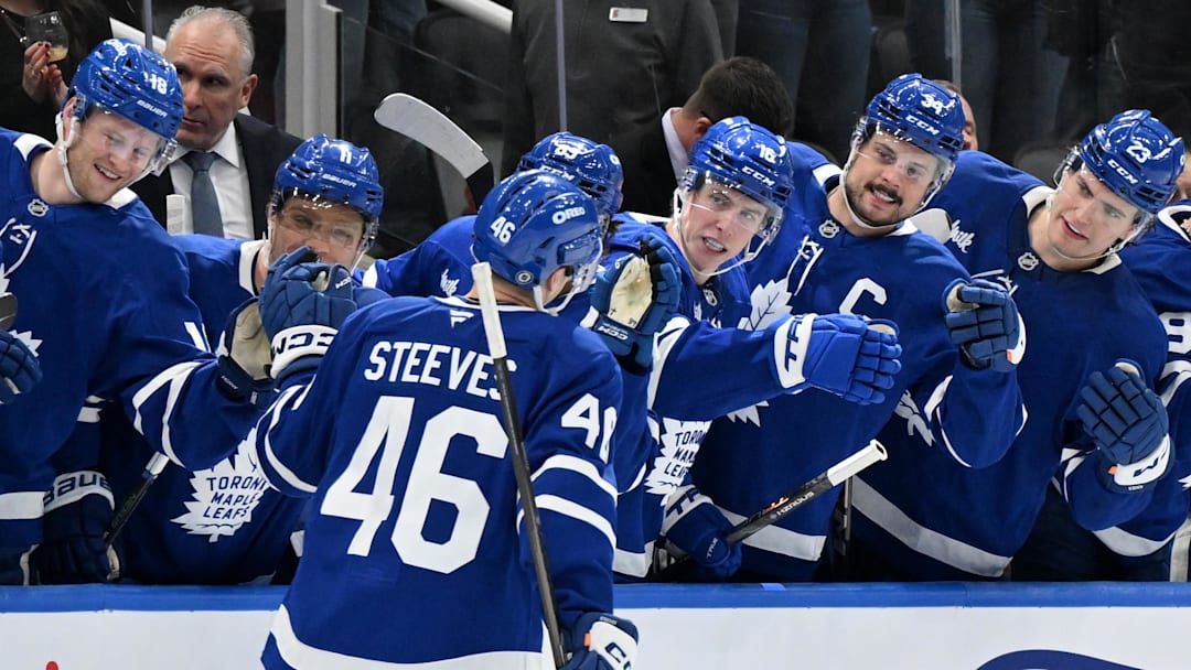 Feb 22, 2025; Toronto, Ontario, CAN;  Toronto Maple Leafs forward Alex Steeves (46) celebrates with teammates at the bench after scoring a goal against the Carolina Hurricanes in the first period at Scotiabank Arena. Mandatory Credit: Dan Hamilton-Imagn Images