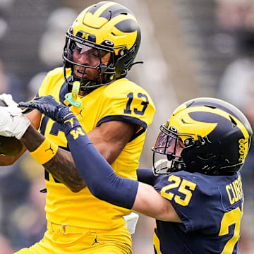 Team Maize wide receiver Donaven McCulley (13) makes a catch against Team Blue defensive back Mason Curtis (25) during the first half of the spring game at Michigan Stadium in Ann Arbor on Saturday, April 19, 2025.