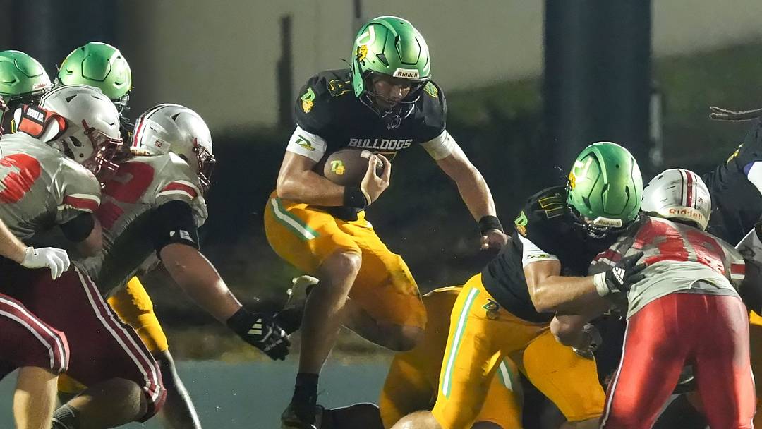 DeLand's Gardner Nordman (4) jumps through a hole and gets a first down during a game against Lake Mary on Sept. 11, 2026 in DeLand. The Bulldogs went on to win, 33-0.