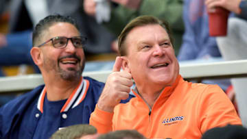Illini head coach Brad Underwood, in orange, and associate head coach Orlando Antigua greets fans at the Class 3A Washington Sectional semifinal Tuesday, March 4, 2025 at Washington Community High School. The Redbirds' rallied to defeat Kankakee 65-63 in overtime.