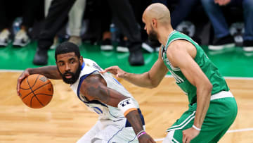 Jun 17, 2024; Boston, Massachusetts, USA; Dallas Mavericks guard Kyrie Irving (11) handles the ball against Boston Celtics guard Derrick White (9) in game five of the 2024 NBA Finals at TD Garden. Mandatory Credit: Peter Casey-USA TODAY Sports