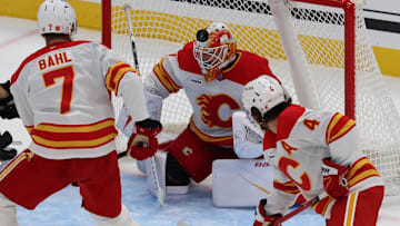 Oct 15, 2025; Salt Lake City, Utah, USA; Calgary Flames goaltender Devin Cooley (1) blocks a shot by the Utah Mammoth during the second period at Delta Center. Mandatory Credit: Rob Gray-Imagn Images