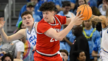 Feb 23, 2025; Los Angeles, California, USA; Ohio State Buckeyes center Austin Parks (25) grabs a rebound in front of UCLA Bruins forward Tyler Bilodeau (34) and UCLA Bruins guard Kobe Johnson (0) during an NCAA basketball game at Pauley Pavilion presented by Wescom. Mandatory Credit: Robert Hanashiro-Imagn Images