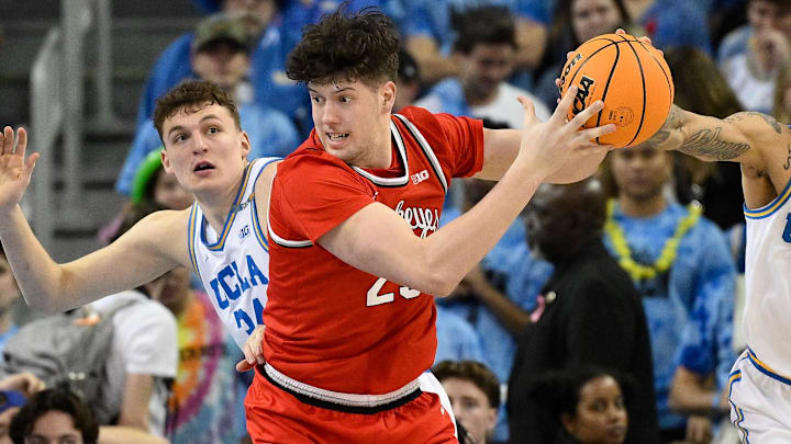 Feb 23, 2025; Los Angeles, California, USA; Ohio State Buckeyes center Austin Parks (25) grabs a rebound in front of UCLA Bruins forward Tyler Bilodeau (34) and UCLA Bruins guard Kobe Johnson (0) during an NCAA basketball game at Pauley Pavilion presented by Wescom. Mandatory Credit: Robert Hanashiro-Imagn Images Feb 23, 2025; Los Angeles, California, USA; Ohio State Buckeyes center Austin Parks (25) grabs a rebound in front of UCLA Bruins forward Tyler Bilodeau (34) and UCLA Bruins guard Kobe Johnson (0) during an NCAA basketball game at Pauley Pavilion presented by Wescom. Mandatory Credit: Robert Hanashiro-Imagn Images