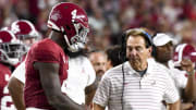 Sep 2, 2023; Tuscaloosa, Alabama, USA;  Alabama Crimson Tide quarterback Jalen Milroe (4) shakes hands with head coach Nick Saban after throwing a touchdown pass against the Middle Tennessee Blue Raiders during the second half at Bryant-Denny Stadium. Alabama won 56-7.