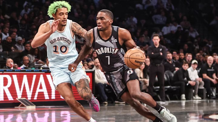 Dec 27, 2024; Brooklyn, New York, USA; Brooklyn Nets guard Shake Milton (7) drives past San Antonio Spurs forward Jeremy Sochan (10) in the third quarter at Barclays Center. Mandatory Credit: Wendell Cruz-Imagn Images