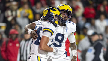 Nov 22, 2025; College Park, Maryland, USA;  Michigan Wolverines quarterback Bryce Underwood (19) celebrates with running back Bryson Kuzdzal (24) after scoring a touchdown during the second half against the Maryland Terrapins at SECU Stadium. Mandatory Credit: Tommy Gilligan-Imagn Images
