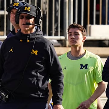 Michigan Wolverines head coach Jim Harbaugh watches from the sideline beside off-field analyst Connor Stalions, right, during the NCAA football game against the Ohio State Buckeyes at Ohio Stadium.