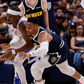 Oklahoma City Thunder guard Shai Gilgeous-Alexander (2) and Denver Nuggets guard Russell Westbrook (4) dive for a loose ball in the fourth quarter during game four of the second round of the 2025 NBA Playoffs at Ball Arena. Mandatory Credit: Isaiah J. Downing-Imagn Images