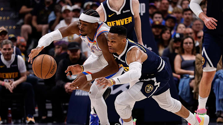 May 11, 2025; Denver, Colorado, USA; Oklahoma City Thunder guard Shai Gilgeous-Alexander (2) and Denver Nuggets guard Russell Westbrook (4) dive for a loose ball in the fourth quarter during game four of the second round of the 2025 NBA Playoffs at Ball Arena. Mandatory Credit: Isaiah J. Downing-Imagn Images