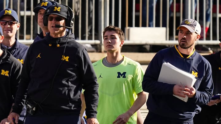 Michigan Wolverines head coach Jim Harbaugh watches from the sideline beside off-field analyst Connor Stalions, right, during the NCAA football game against the Ohio State Buckeyes at Ohio Stadium.