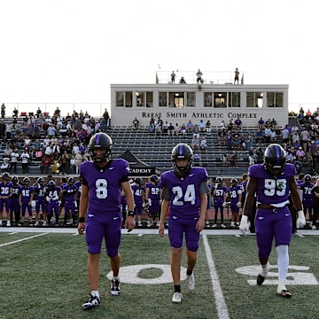 Lipscomb Academy's Tav Shaffer (8), Brennan Pepper (24), and Tony Carter (99) walk to midfield for the coin flip during an high school football game against First Academy Thursday, Aug. 22, 2024, in Nashville, Tenn.