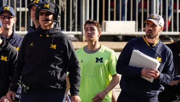 Michigan Wolverines head coach Jim Harbaugh watches from the sideline beside off-field analyst Connor Stalions, right, during the NCAA football game against the Ohio State Buckeyes at Ohio Stadium.