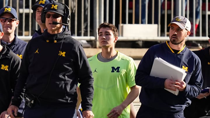 Nov 26, 2022; Columbus, Ohio, USA; Michigan Wolverines head coach Jim Harbaugh watches from the sideline beside off-field analyst Connor Stalions, right, during the NCAA football game against the Ohio State Buckeyes at Ohio Stadium.