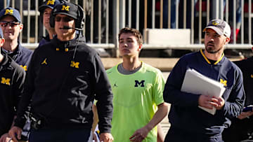 Michigan Wolverines head coach Jim Harbaugh watches from the sideline beside off-field analyst Connor Stalions, right, during the NCAA football game against the Ohio State Buckeyes at Ohio Stadium.