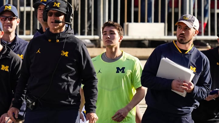 Michigan Wolverines head coach Jim Harbaugh watches from the sideline beside off-field analyst Connor Stalions, right, during the NCAA football game against the Ohio State Buckeyes at Ohio Stadium.