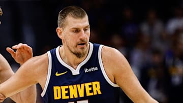 Nov 3, 2025; Denver, Colorado, USA; Denver Nuggets center Nikola Jokic (15) dribbles the ball up court as Sacramento Kings forward Domantas Sabonis (11) defends in the first quarter at Ball Arena. Mandatory Credit: Isaiah J. Downing-Imagn Images