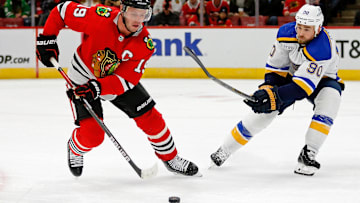 Sep 27, 2022; Chicago, Illinois, USA; Chicago Blackhawks center Jonathan Toews (19) controls the puck while defended by St. Louis Blues center Ryan O'Reilly (90) during the second period at United Center. Mandatory Credit: Jon Durr-Imagn Images