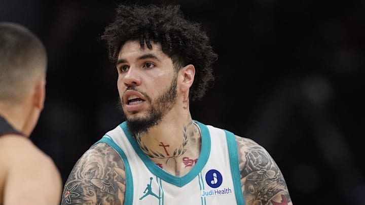 Apr 14, 2026; Charlotte, North Carolina, USA; Charlotte Hornets guard LaMelo Ball (1) looks to pass defended by Miami Heat guard Tyler Herro (14) during the second half during the play-in rounds between the Charlotte Hornets and the Miami Heat of the 2026 NBA Playoffs at Spectrum Center. Mandatory Credit: Jim Dedmon-Imagn Images