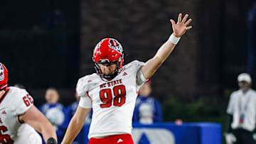 Oct 14, 2023; Durham, North Carolina, USA; North Carolina State Wolfpack punter Caden Noonkester (98) kicks the football during the first half of the game against Duke Blue Devils at Wallace Wade Stadium. Mandatory Credit: Jaylynn Nash-Imagn Images