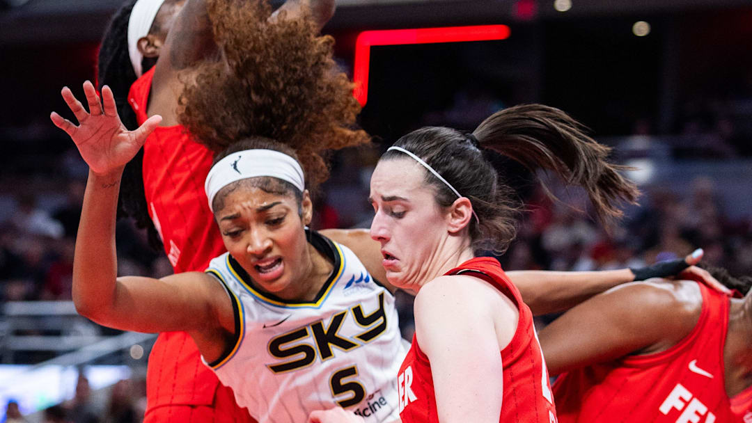 Indiana Fever guard Caitlin Clark steals the ball from Chicago Sky forward Angel Reese.