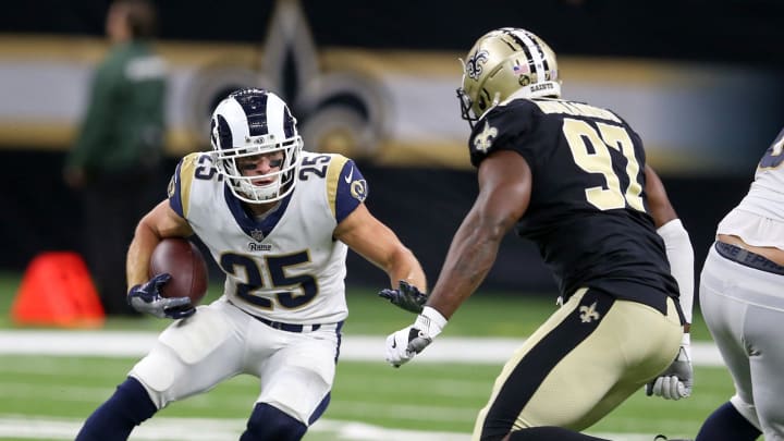 Aug 30, 2018; New Orleans, LA, USA; Los Angeles Rams running back Nick Holley (25) is defended by New Orleans Saints defensive end Al-Quadin Muhammad (97) in the second half at Mercedes-Benz Superdome. The Saints won, 28-0. Mandatory Credit: Chuck Cook-USA TODAY Sports