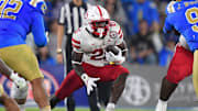 Emmett Johnson runs the ball against the UCLA Bruins during the second half at the Rose Bowl. 