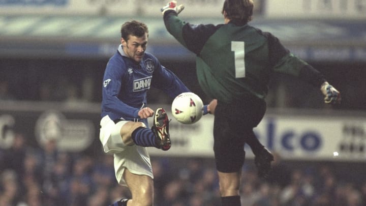 Duncan Ferguson of Everton (left) tries to chips the ball past the Swindon goalkeeper