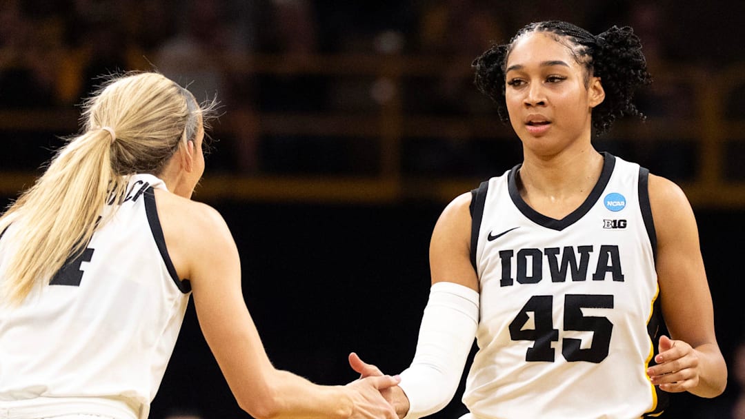 Iowa guard Kylie Feuerbach (4) high-fives Iowa forward Hannah Stuelke (45) March 21, 2026 during a First Round NCAA March Madness game against the Fairleigh Dickinson Knights at Carver-Hawkeye Arena in Iowa City, Iowa.