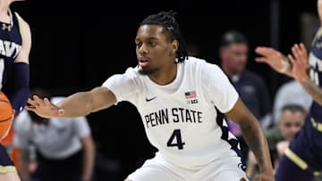 Nov 11, 2025; University Park, Pennsylvania, USA; Penn State Nittany Lions guard Kayden Mingo (4) defends as Navy Midshipmen guard Austin Benigni (1) holds the ball during the first half at Bryce Jordan Center. Mandatory Credit: Matthew O'Haren-Imagn Images