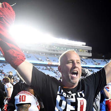 Nov 25, 2022; Chapel Hill, North Carolina, USA; North Carolina State Wolfpack head coach Dave Doeren  celebrates after the game at Kenan Memorial Stadium. Mandatory Credit: Bob Donnan-Imagn Images