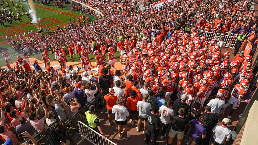 Clemson football team runs down the hill after rubbing Howard’s Rock before the game with Southern Methodist University at Memorial Stadium in Clemson Saturday, October 18, 2025.