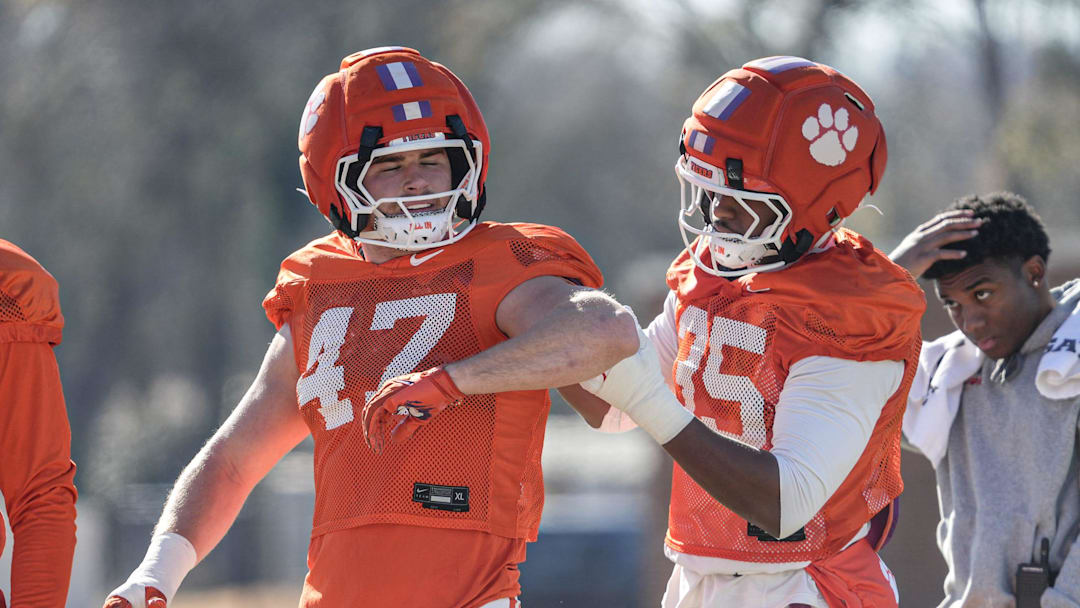 Jeremiah Alexander (35) helps Sammy Brown (47) with his jersey during the Pinstipe Bowl practice in Clemson, S.C. Monday, Dec. 15, 2025.