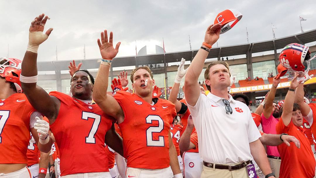 Clemson linebacker Jeremiah Alexander (7), quarterback Tait Reynolds (2) and assistant coach Hunter Helms sing the alma mater after Clemson's victory