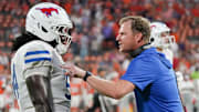 SMU coach Rhett Lashlee speaks to offensive lineman Savion Byrd