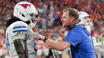 Oct 18, 2025; Clemson, South Carolina, USA; Southern Methodist Mustangs head coach Rhett Lashlee talks with Southern Methodist University offensive lineman Savion Byrd (54) on the sidelines against the Clemson Tigers during the fourth quarter at Memorial Stadium. Mandatory Credit: Ken Ruinard-GREENVILLE NEWS-USA TODAY Network via Imagn Images