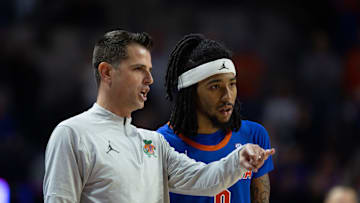 Florida head coach Todd Golden talks with Florida guard Boogie Fland (0) during the second half of an NCAA mens basketball against Florida State game at Exactec Areana at the Steven C. O Connell Center in Gainesville, FL on Tuesday, November 11, 2025. Florida beat FSU 78-76, [Alan Youngblood/Gainesville Sun]