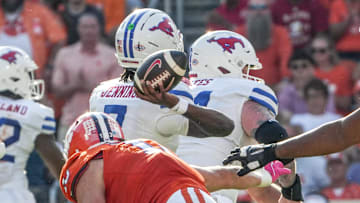 Oct 18, 2025; Clemson, South Carolina, USA; Southern Methodist Mustangs quarterback Kevin Jennings (7) passes near Clemson Tigers defensive end Will Heldt (13) during the second quarter at Memorial Stadium. Mandatory Credit: Ken Ruinard-GREENVILLE NEWS-USA TODAY Network via Imagn Images