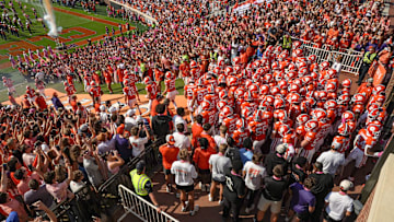 Clemson football team runs down the hill after rubbing Howard’s Rock before the game with Southern Methodist University at Memorial Stadium in Clemson Saturday, October 18, 2025.
