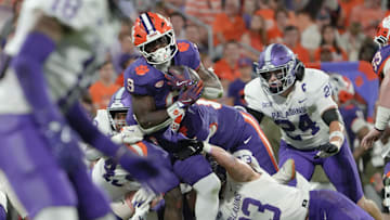 Clemson running back Gideon Davidson (9) runs near Furman University linebacker Luke McLaughlin (23) during the second quarter at Memorial Stadium in Clemson, S.C. Saturday, November 22, 2025.