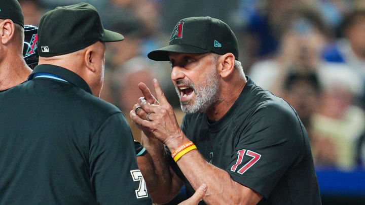 Jul 22, 2024; Kansas City, Missouri, USA; Arizona Diamondbacks manager Torey Lovullo (17) talks with umpire Brian O'Nora (7) during the seventh inning against the Kansas City Royals at Kauffman Stadium. Mandatory Credit: Jay Biggerstaff-USA TODAY Sports