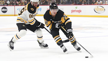 Mar 1, 2025; Pittsburgh, Pennsylvania, USA;  Pittsburgh Penguins left wing Anthony Beauvillier (72) moves the puck against Boston Bruins right wing David Pastrnak (88) during the third period at PPG Paints Arena. Mandatory Credit: Charles LeClaire-Imagn Images