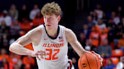 Mar 7, 2025; Champaign, Illinois, USA;  Illinois Fighting Illini guard Kasparas Jakucionis (32) drives the ball during the first half against the Purdue Boilermakers at State Farm Center. Mandatory Credit: Ron Johnson-Imagn Images
