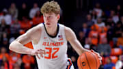 Mar 7, 2025; Champaign, Illinois, USA;  Illinois Fighting Illini guard Kasparas Jakucionis (32) drives the ball during the first half against the Purdue Boilermakers at State Farm Center. Mandatory Credit: Ron Johnson-Imagn Images