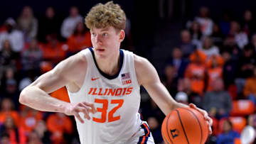 Mar 7, 2025; Champaign, Illinois, USA;  Illinois Fighting Illini guard Kasparas Jakucionis (32) drives the ball during the first half against the Purdue Boilermakers at State Farm Center. Mandatory Credit: Ron Johnson-Imagn Images
