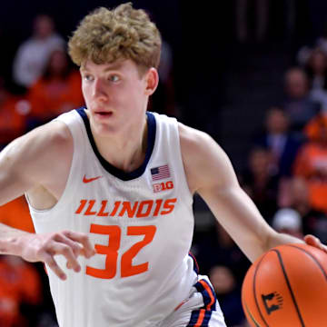 Mar 7, 2025; Champaign, Illinois, USA;  Illinois Fighting Illini guard Kasparas Jakucionis (32) drives the ball during the first half against the Purdue Boilermakers at State Farm Center. Mandatory Credit: Ron Johnson-Imagn Images