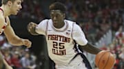 Feb 21, 2016; Madison, WI, USA; Illinois Fighting Illini guard Kendrick Nunn (25) moves the ball against Wisconsin Badgers forward Alex Illikainen (25) during the game at the Kohl Center.  Wisconsin defeated Illinois 69-60.  Mandatory Credit: Mary Langenfeld-Imagn Images