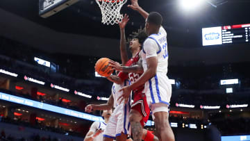 Louisville   s Skyy Clark looks for a shot under the rim against the Kentucky defense in the second half. The Wildcats won 95-76 at the KFC Yum! Center on Thursday, December 21, 2023
