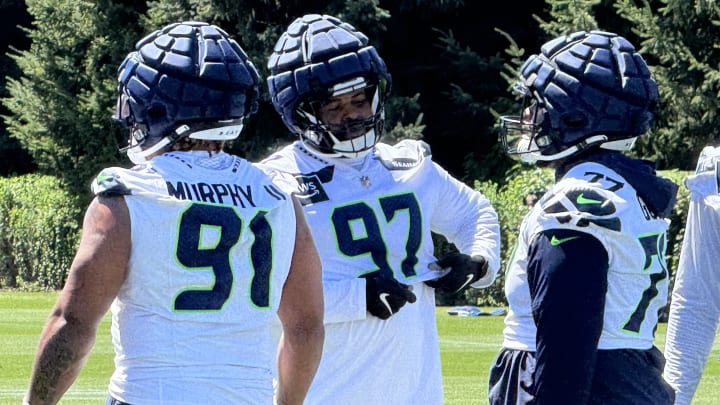 Seattle Seahawks defensive tackle Johnathan Hankins chats with teammates Matt Gotel and Byron Murphy II at training camp.